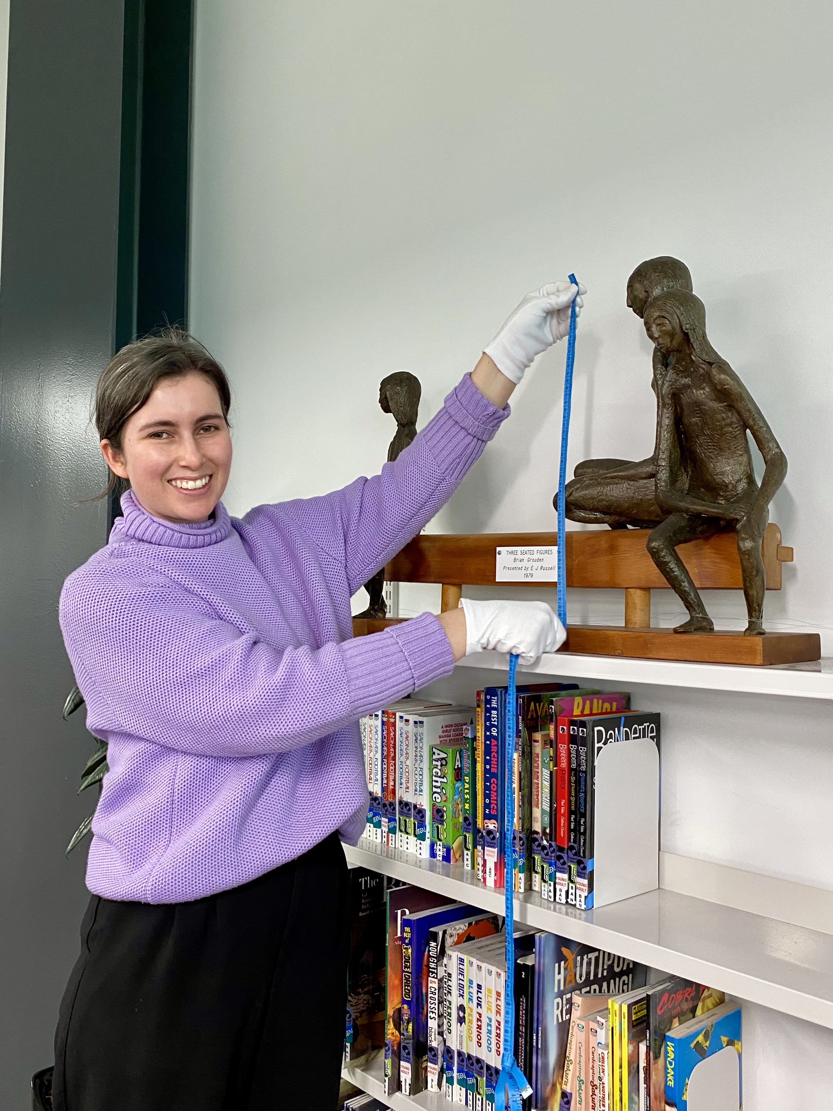 Pieces to be retained include the bronze sculpture Three Seated Figures by Brian Grouden. This piece, being sized by collections manager, Sarah Dawe, is currently on display in the Te Awamutu library.