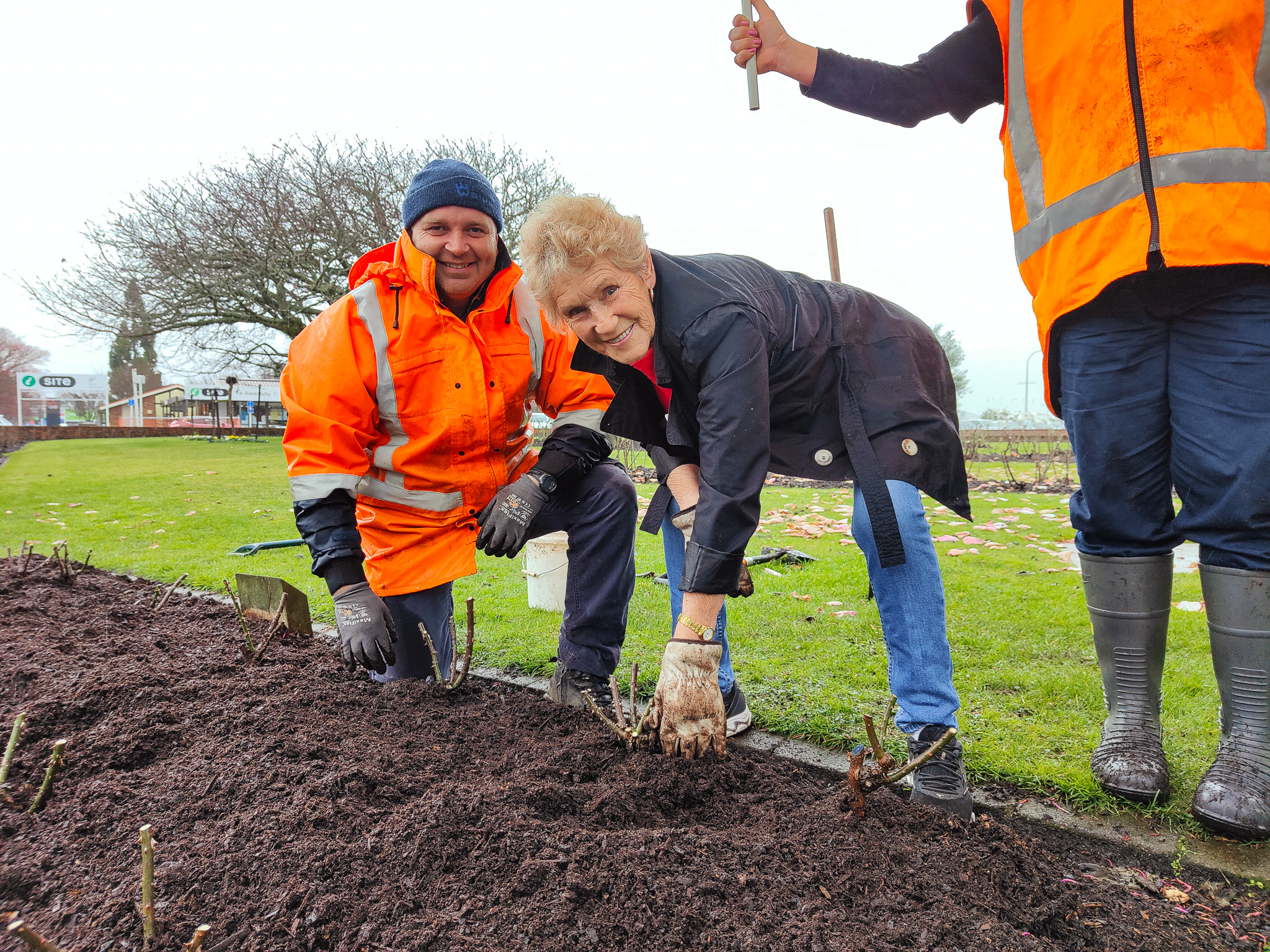 Parks team Leading Hand Mike Tobin and Rose Society president Diana Jones plant the final rose of the ceremony