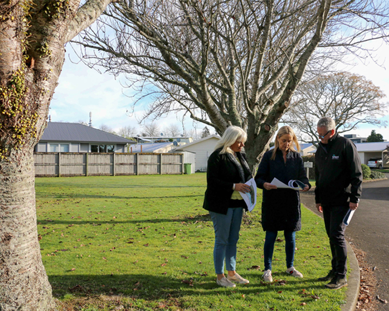 people standing in front of trees on Vaile Court in Leamington. 